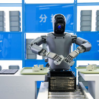 A humanoid robot from "Walker" series of UBTECH conducts sorting work at the Beijng World of Robots in Beijing