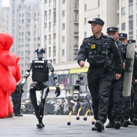 Police men and robots patrol in Hangzhou City, 13 February, 2026.