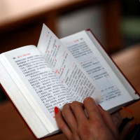 Woman reading a chinese bible.