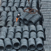 Steel is hoisted and stacked at a steel market in Hangzhou, Zhejiang province