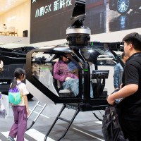 Visitors check out the cockpit section of Xpeng Aeroht's modular flying car 'Land Aircraft Carrier' at the 2026 Beijing Auto Show in Beijing, 28 April, 2026.