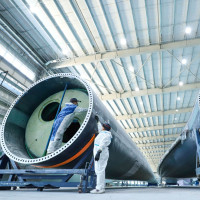 staff member uses intelligent inspection technology to check the quality of fan blades on the inspection line of Shanghai Electric's wind turbine blade production line, located in Nanhua Industrial Park, Gaotai County, Zhangye city, Gansu province, China, March 7, 2024.