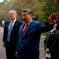 Chinese President Xi Jinping, center, gestures as he greets U.S. President Donald Trump at Zhongnanhai Garden in Beijing, Friday, May 15, 2026.