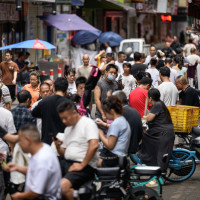 : A view of the street, where recruitment takes place in Datang Village, functions as a central labor market for the garment industry in urban villages in Guangzhou, China on July 11, 2025