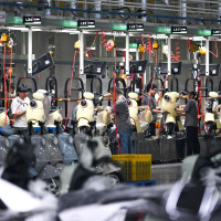 Workers assemble electric two-wheelers at AIMA Technology's production line in Tongliang District, southwest China's Chongqing, June 17, 2026.