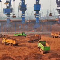 Trucks dump bauxite imported from Guinea into a pile at a ore dock in Yantai in eastern China's Shandong province, Wednesday, March 25, 2026. Bauxite smelters produce rare-earth elements (REEs) as a byâproduct, Credit:TANG KE / Avalon