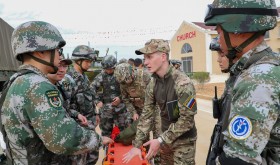 Chinese and Russian soldiers communicate with each other during a joint exercise