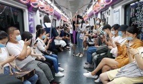 People on their phones in a Beijing subway