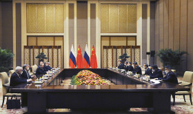 Chinese President Xi Jinping, fourth right, and Russian President Vladimir Putin, fourth left, attend talks in Beijing, China, Friday, Feb. 4, 2022.