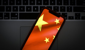 The Chinese flag is seen on a portable mobile device in this photo illustration