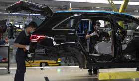 Workers assemble cars at a Beijing Benz Automotive Co. Ltd factory, a German joint venture company for Mercedes-Benz, in Beijing.