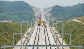 A track-laying train performs ballastless track-laying