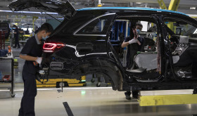 Workers assemble cars at a Beijing Benz Automotive Co. Ltd factory, a German joint venture company for Mercedes-Benz, in Beijing