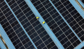 Construction workers install photovoltaic modules on the roof of Tongwei Electric Haian Co., LTD in Hai 'an, Jiangsu province, China, November 19, 2024.