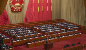 Chinese Premier Li Qiang speaks from a lectern during the opening session of the National People's Congress (NPC) at the Great Hall of the People in Beijing, China, Wednesday, March 5, 2025.