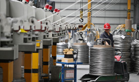 A worker produces bonding wire for domestic and international markets at a workshop in Jiangsu.