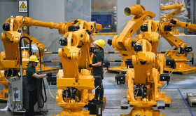 Workers assemble industrial robots at a robot manufacturer in Nanjing city in east China's Jiangsu province.