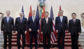 In this photo released by Xinhua News Agency, Chinese Vice Premier He Lifeng, center right, and U.S. Treasury Secretary Scott Bessent, center left, pose for a group photo with delegations before their meeting to discuss China-U.S. trade, in London, Monday, June 9, 2025.