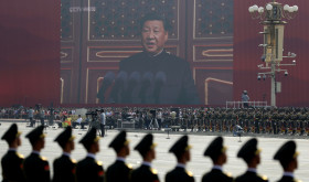 A huge screen shows Chinese President Xi Jinping delivering a speech at the start of a parade to mark the 70th anniversary of the founding of the People's Republic of China, in Beijing, Tuesday, Oct. 1, 2019. (AP Photo/Mark Schiefelbein)