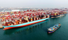 A cargo ship is loading and unloading foreign trade containers at the Qingdao Port Automated Terminal in Shandong Province, China on January 14, 2026