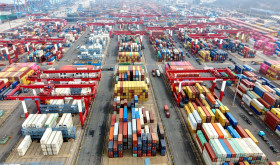 Vehicles are loading containers at Qingdao Port Foreign Trade Container Terminal in Shandong Province, China