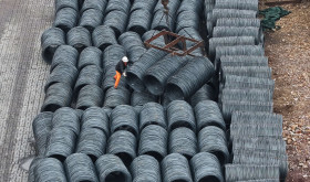 Steel is hoisted and stacked at a steel market in Hangzhou, Zhejiang province