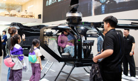 Visitors check out the cockpit section of Xpeng Aeroht's modular flying car 'Land Aircraft Carrier' at the 2026 Beijing Auto Show in Beijing, 28 April, 2026.