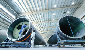 staff member uses intelligent inspection technology to check the quality of fan blades on the inspection line of Shanghai Electric's wind turbine blade production line, located in Nanhua Industrial Park, Gaotai County, Zhangye city, Gansu province, China, March 7, 2024.