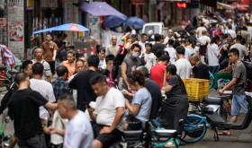 : A view of the street, where recruitment takes place in Datang Village, functions as a central labor market for the garment industry in urban villages in Guangzhou, China on July 11, 2025