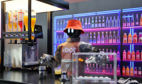 A humanoid robot showcases its cocktail making skills at the 2026 World Robot Conference in Beijing.
