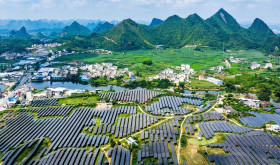 A vast array of deep-blue solar panels stretches across karst mountains at the Hongqi photovoltaic power base in Dahua Yao Autonomous County, Hechi, south China's Guangxi Zhuang Autonomous Region, Sept. 9, 2026, blending with scattered homes and farmland. (Photo by Imaginechina/Sipa USA)