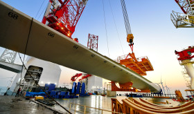 This photo taken on Jan. 13, 2026 shows one of the turbine blades being hoisted at the construction site of a 20-megawatt offshore wind turbine unit in the coastal waters of southeast China's Fujian Province. 