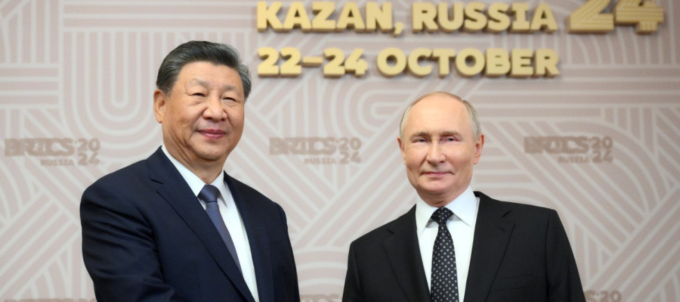 Russian President Vladimir Putin, right, welcomes Chinese President Xi Jinping, for the 16th BRICS summit at the Kazan Kremlin