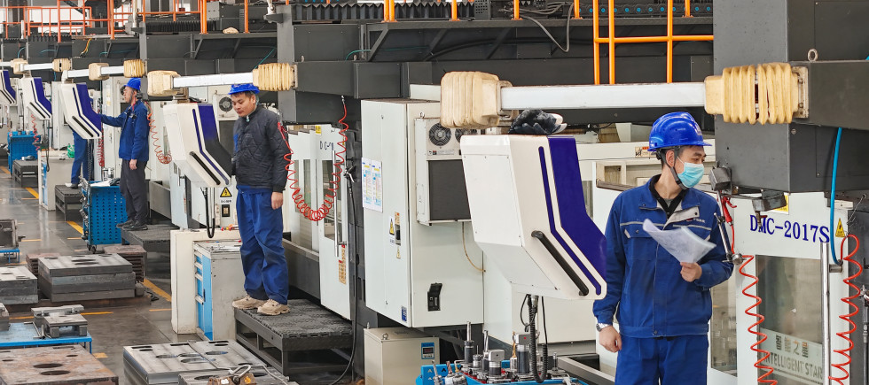Workers produce slitting machine parts at Qingdao Kaisheng CNC Equipment Co., LTD., in Qingdao, Shandong province, China, November 28, 2024