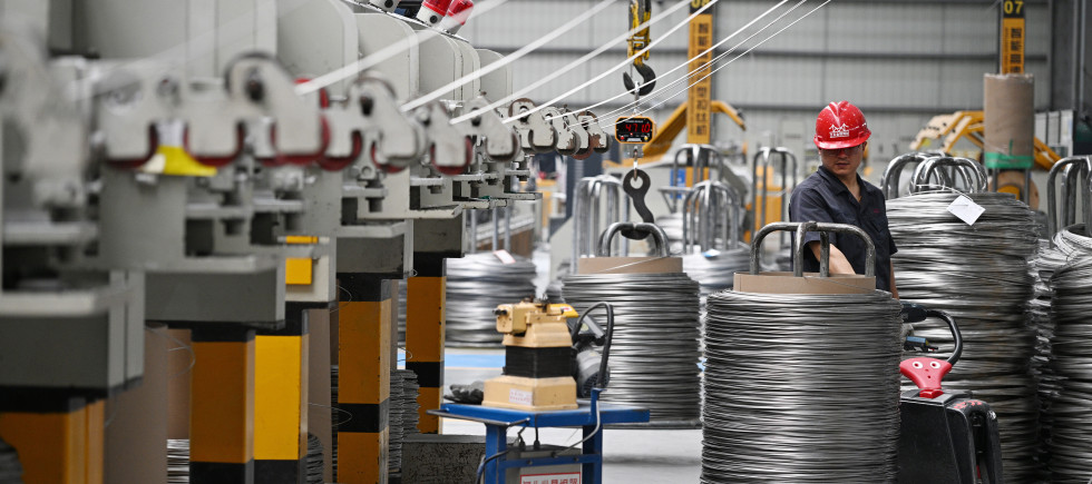 A worker produces bonding wire for domestic and international markets at a workshop in Jiangsu.