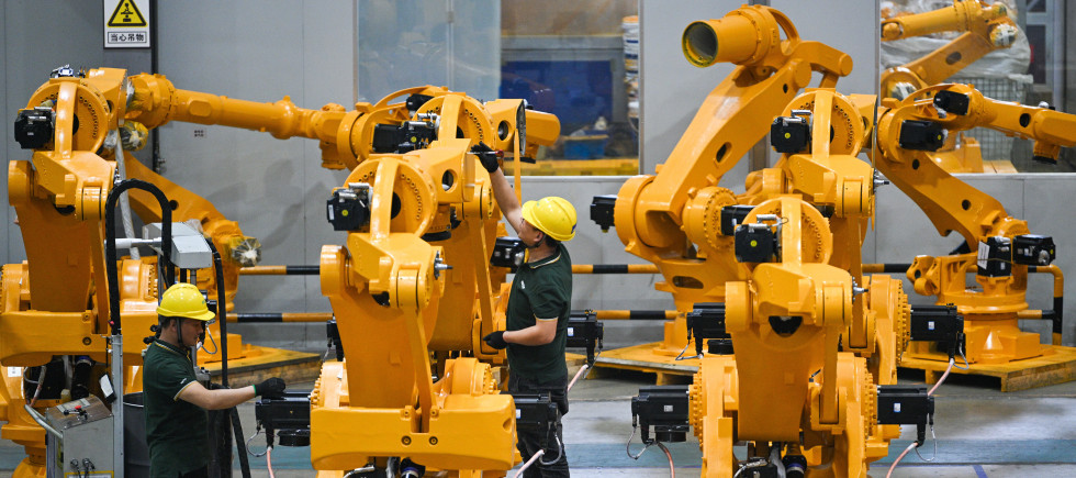 Workers assemble industrial robots at a robot manufacturer in Nanjing city in east China's Jiangsu province.
