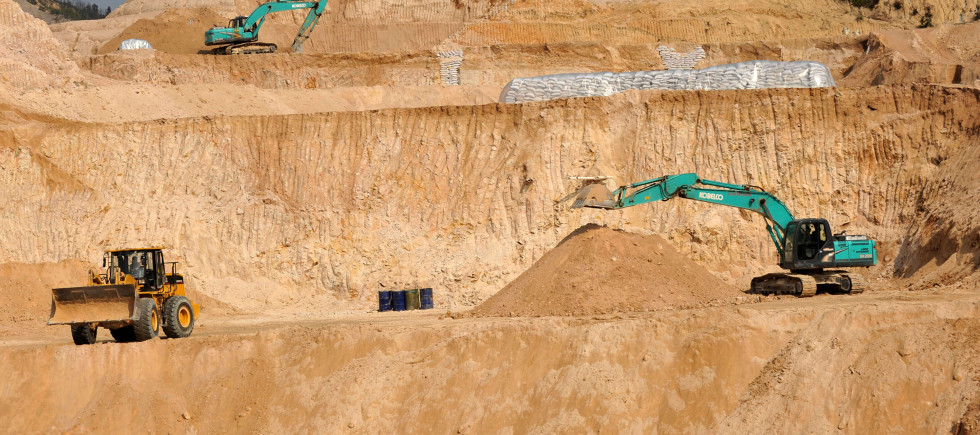 Workers use machinery to dig at a rare earth mine in Ganxian county in central China's Jiangxi province on Dec. 30, 2010.
