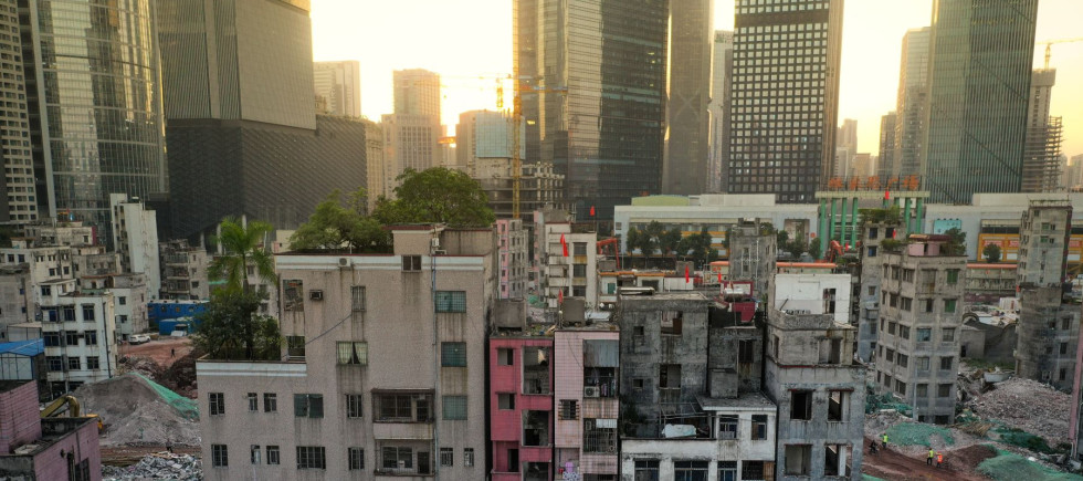 A sharp contrast between Xian village and skyscrapers around in Guangzhou city, south China's Guangdong province.