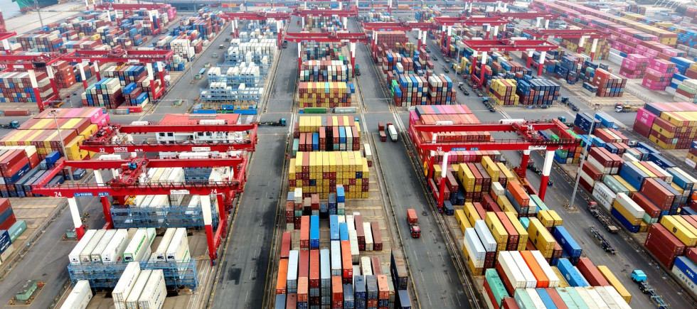 Vehicles are loading containers at Qingdao Port Foreign Trade Container Terminal in Shandong Province, China