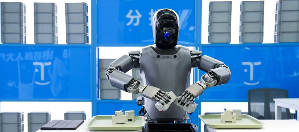 A humanoid robot from "Walker" series of UBTECH conducts sorting work at the Beijng World of Robots in Beijing