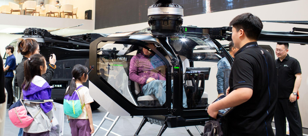 Visitors check out the cockpit section of Xpeng Aeroht's modular flying car 'Land Aircraft Carrier' at the 2026 Beijing Auto Show in Beijing, 28 April, 2026.