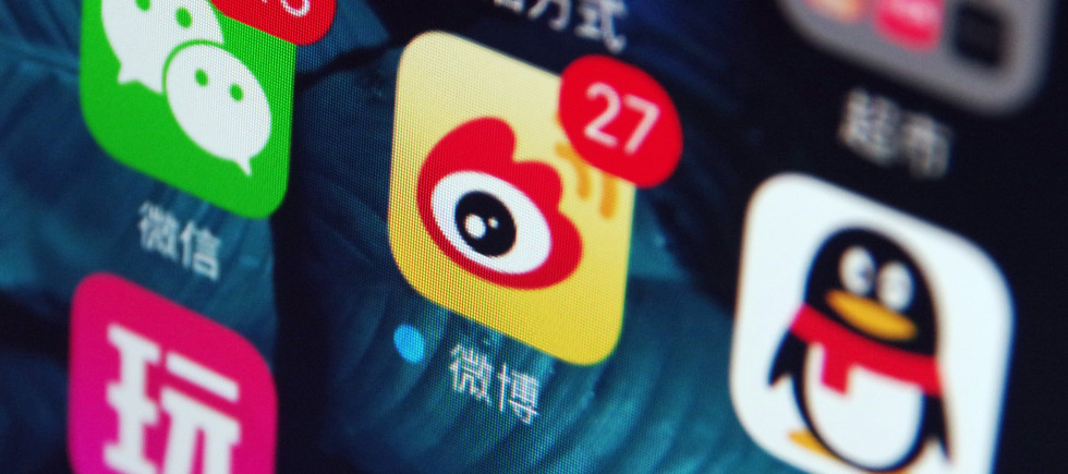 Icons of the messaging apps Weixin (WeChat), left, QQ, right, and Weibo, center