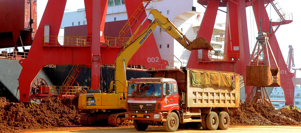 -An excavator loads a truck with rare earth on a quay at the Port of Lianyungang in Lianyungang city, east Chinas Jiangsu province, 10 March 2013.
