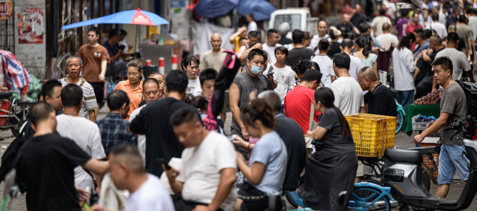 : A view of the street, where recruitment takes place in Datang Village, functions as a central labor market for the garment industry in urban villages in Guangzhou, China on July 11, 2025