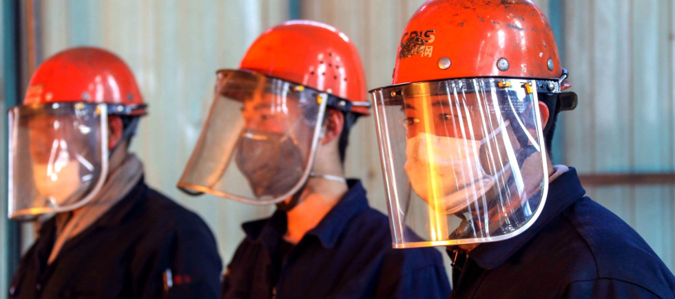 Chinese workers survey the production of steel at a plant of Qingdao Special Iron and Steel Co., Ltd. in Qingdao city.