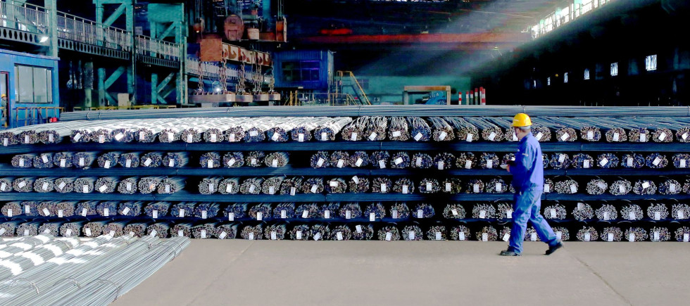 A technician inspects the quality of steel products to be delivered, Zhangjiakou City, Hebei Province, China