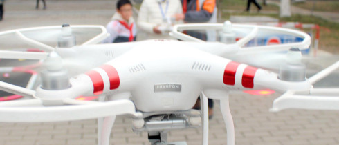 A Chinese girl operates an unmanned aerial vehicle (UAV), or drone, in Suzhou city, east China's Jiangsu province