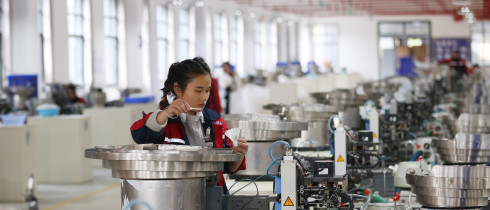 A worker assembles a badminton ball in a production base in Jinping County, Guizhou Province. 