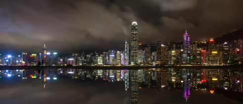 Night view of skyscrapers and high-rise buildings in Central along the Victoria Harbor in Hong Kong