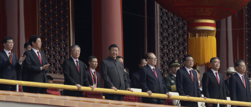 Chinese President Xi Jinping, center, stands with other Chinese leaders to watch a parade as Communist Party celebrates its 70th anniversary in Beijing, Tuesday, Oct. 1, 2019